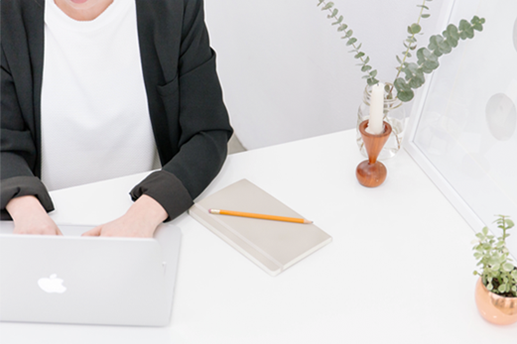 Image of a woman sitting at her desk